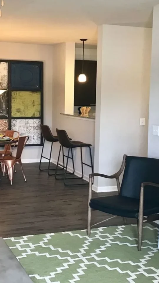 a living room and dining area with green walls at The Creekside at Kenneys Fort