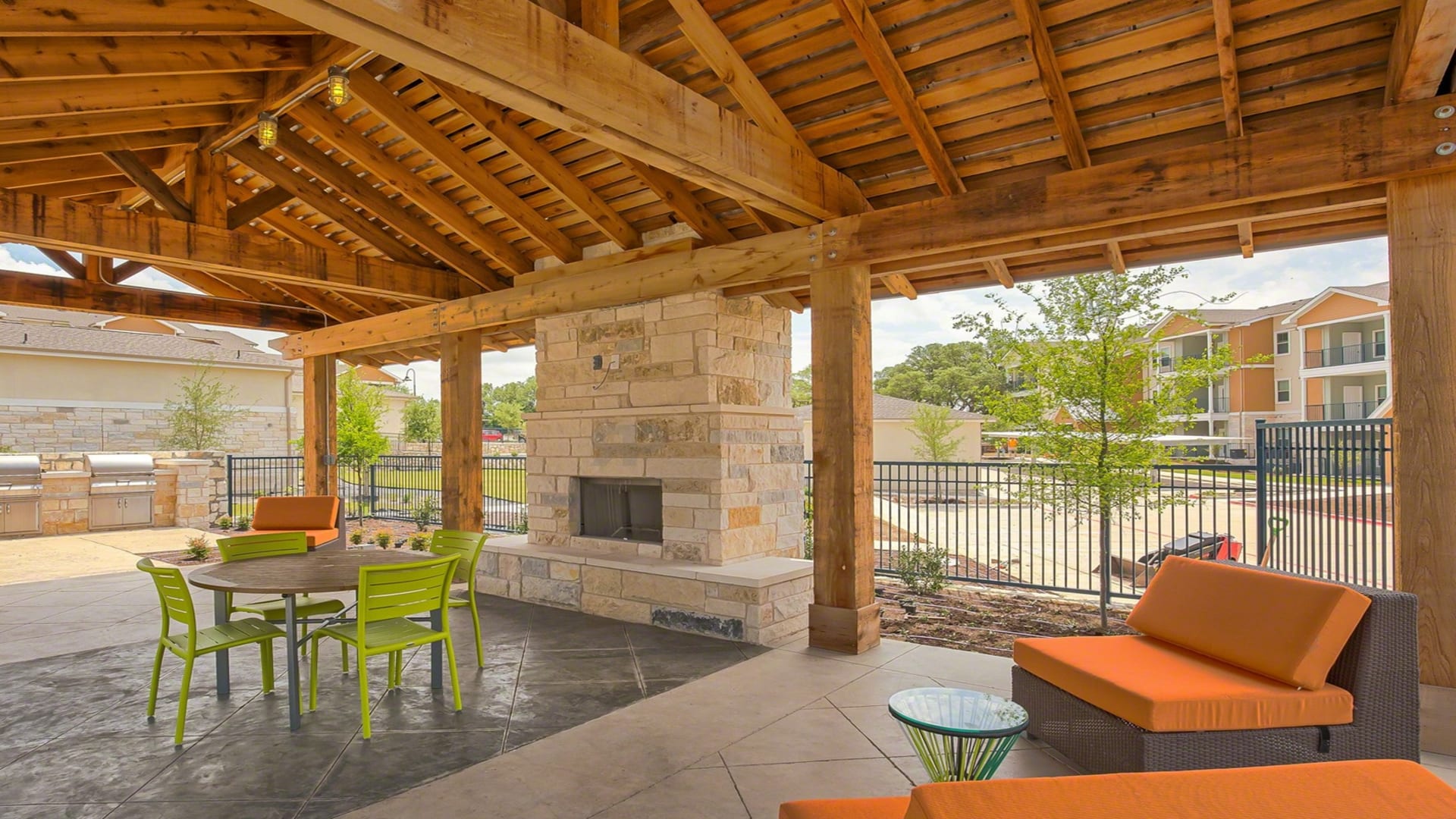 outdoor living area with fireplace and seating area at The Creekside at Kenneys Fort