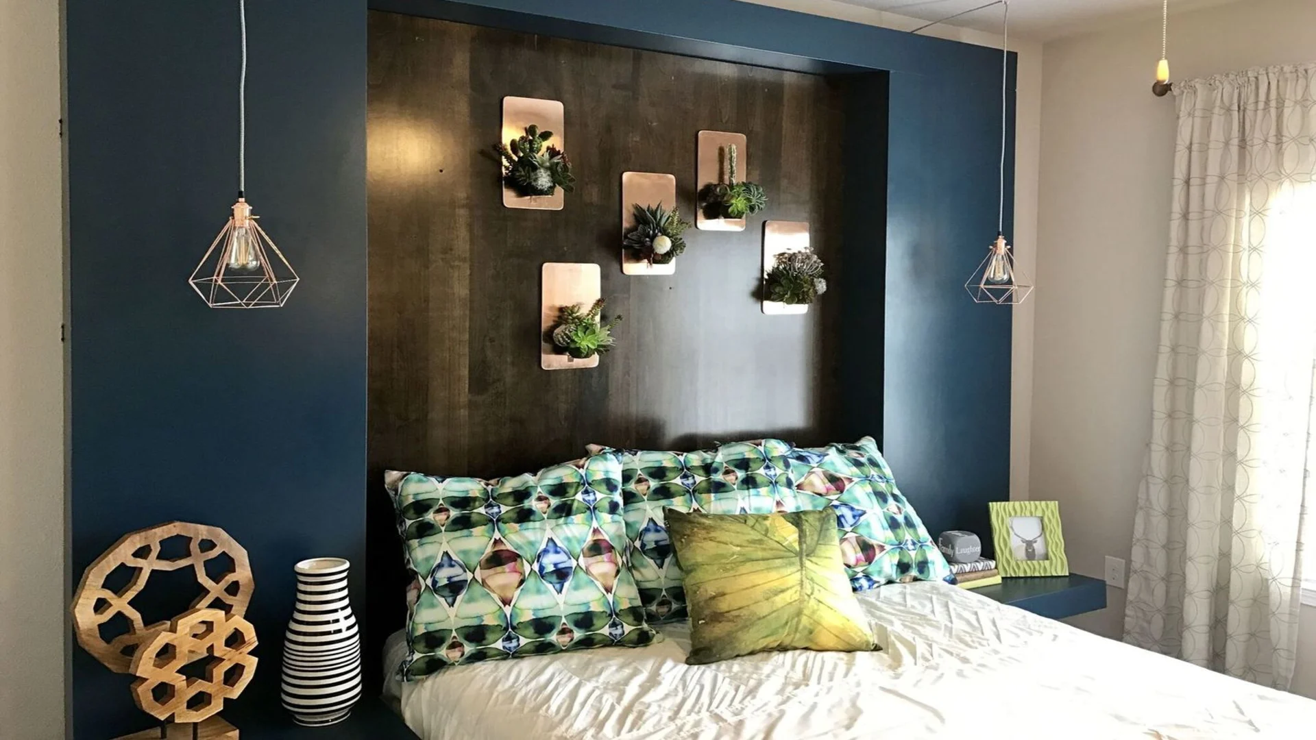 a bedroom with blue walls and a headboard at The Creekside at Kenneys Fort
