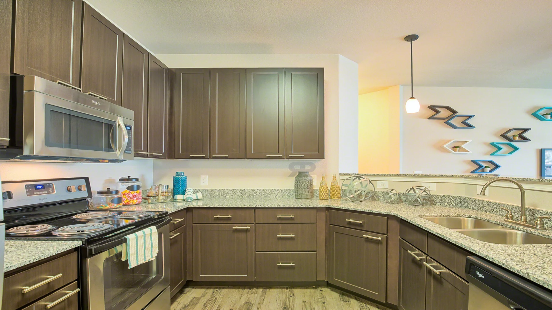 a kitchen with stainless steel appliances and granite counter tops at The Creekside at Kenneys Fort